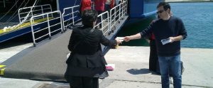 man handing out leaflets on the sea side