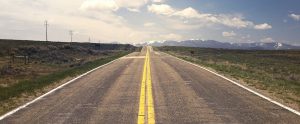 single highway road with grass on the side