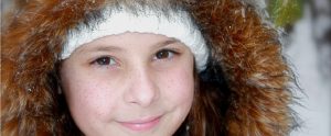young child wearing a fur coat
