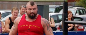 masculine professional powerlifter competing in a strongman competition