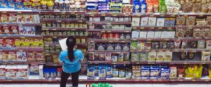 a supermarket woman checking the shopping aisle