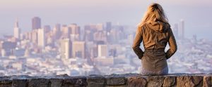 blonde youth woman sitting facing a victy