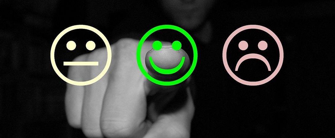 a man pointing at a smiling green cartoon face