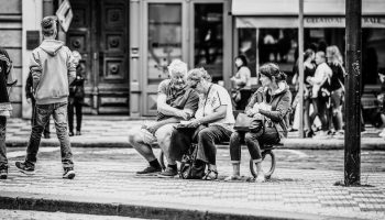 black and white image of people on the sidewalk