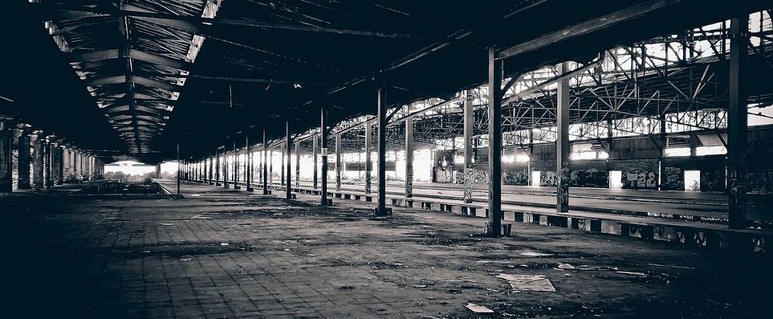 black and white image of a derelict and empty factory