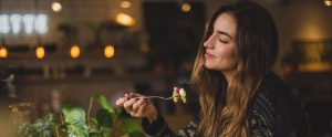 a woman eating pasta