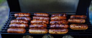 sausages being grilled on a barbecue
