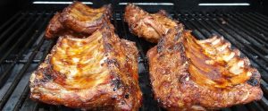 cooked ribs on a metal grill