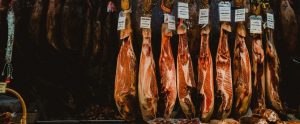raw meat being hung upside down