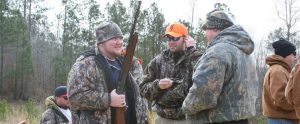 hunters standing together in circles holding rifles