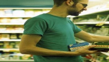 man buying butter from a supermarket