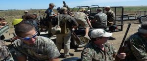 hunters in camo on trucks