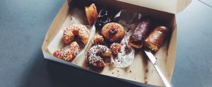 a box with a mixture of chocolate and sugared donuts