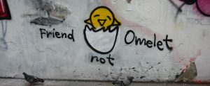 graffiti on a wall that says "friend not omelet"