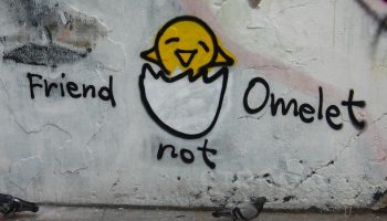 graffiti on a wall that says "friend not omelet"