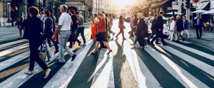 people walking over a zebra crossing
