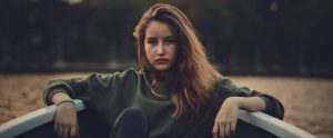 a young woman in a boat on a lake