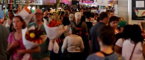 crowd of people walking down a shopping street