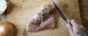 cutting raw seasoned meat