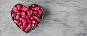 a heart shaped container full of red sweets