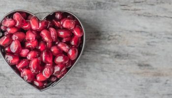 a heart shaped container full of red sweets
