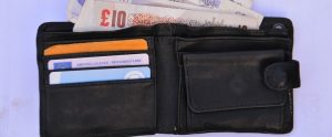 a open wallet with British pounds in it