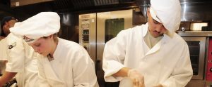 culinary school students cooking in a kitchen