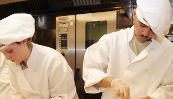 culinary school students cooking in a kitchen