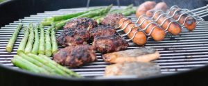 man grilling meat on a barbecue