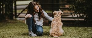 a child petting her companion animal