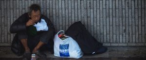 homeless asian man eating food