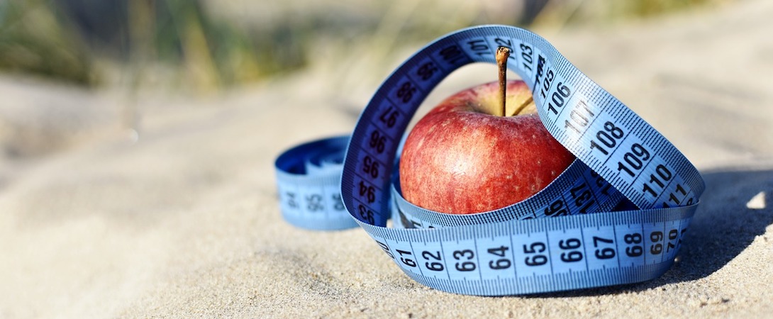 apple with a measuring tape around it