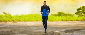 black man jogging on a road