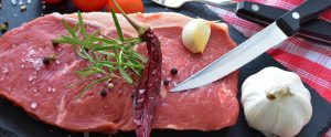 uncooked steak with a knife on it