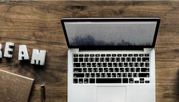 MacBook computer with the words "DREAM" next to it