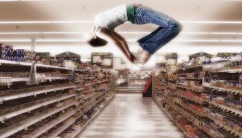 woman doing a backflip in a shopping aisle
