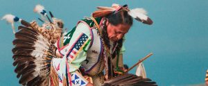 an American indigenous person in traditional costume