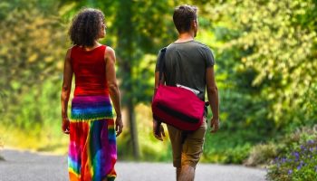 two people walking down a road