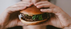 a burger in someone's hands
