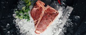 steak on ice with coriander and a knife