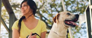 person in yellow shirt with dog