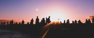 silhouettes of people near the water
