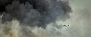 plane-flying-into-smoke