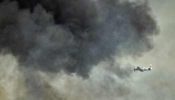 plane-flying-into-smoke