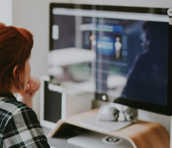 person looking at blurred computer screen