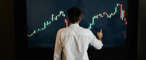 person pointing at large graph