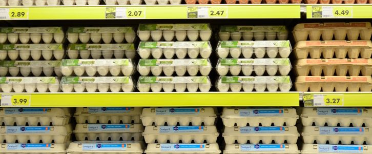 supermarket shelves stacks of egg cartons