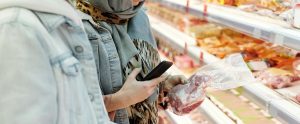 two people grocery shopping for meat