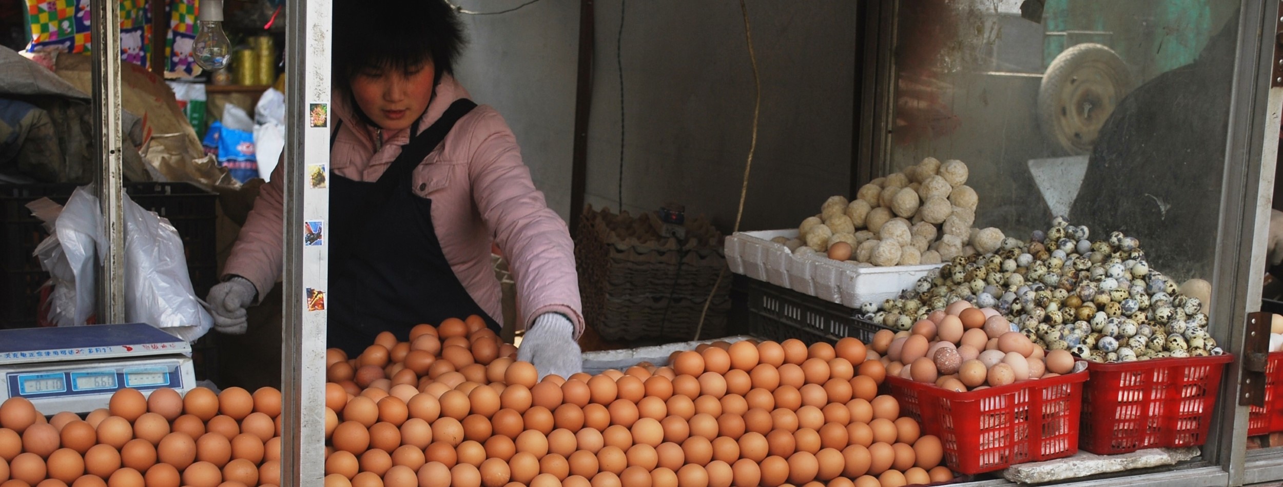 person selling eggs from market stall China