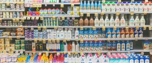 shelves of plant-based milk alternatives in grocery store